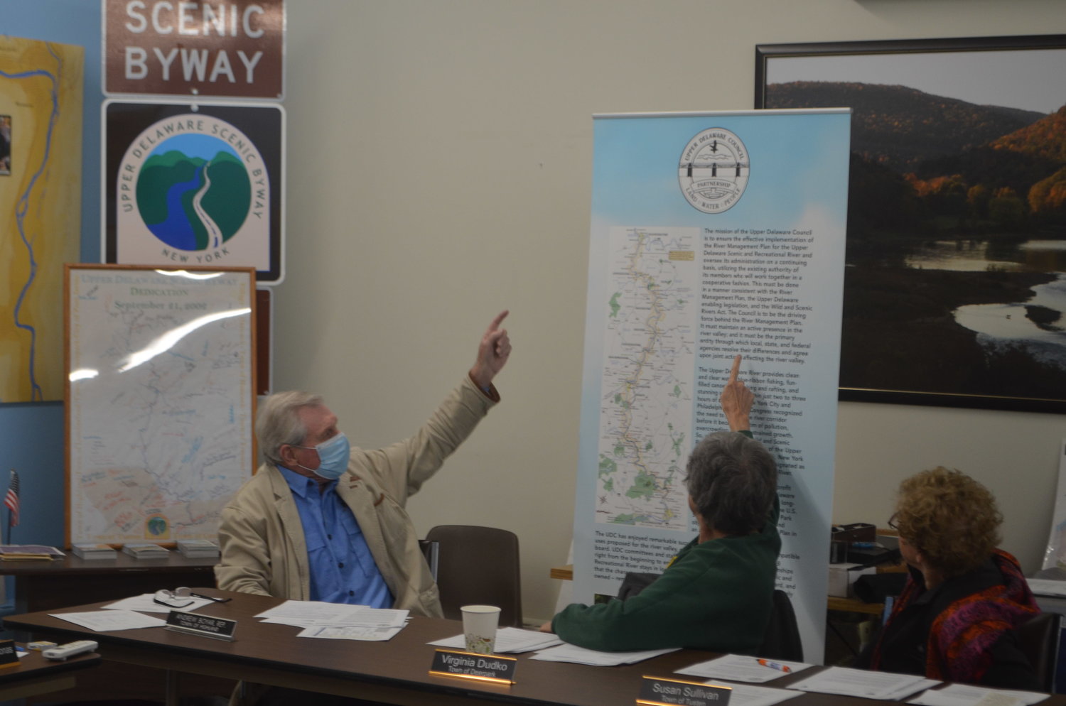 UDC Highland alternate representative Andy Boyar, left, pointing with Deerpark alternate representative Virginia Dudko and Tusten representative Susan Sullivan at the text of the River Management Plan.